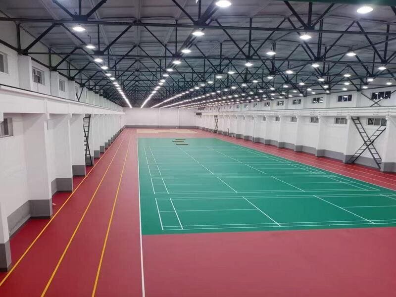 PVC sports flooring rolls stacked in a distributor warehouse